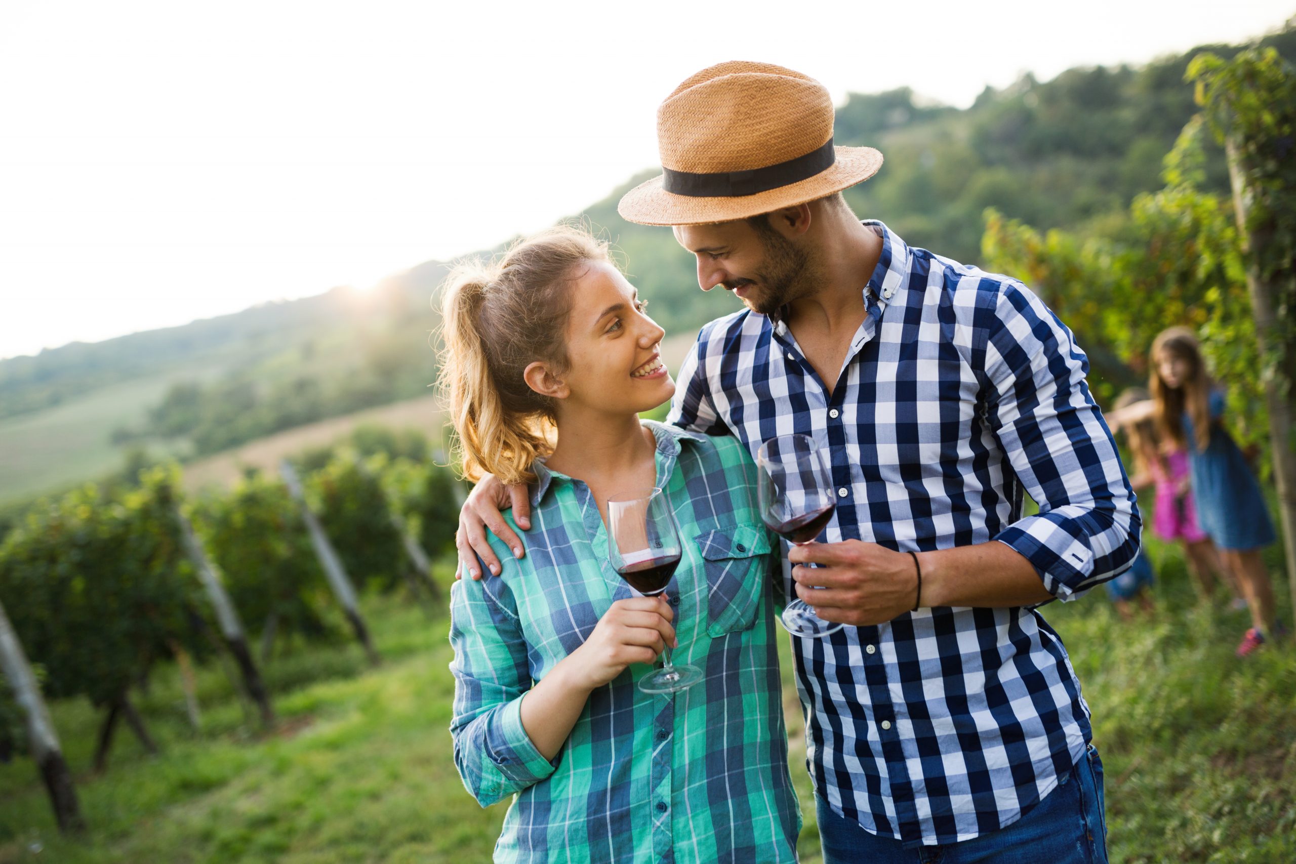 couple drinking wine in vineyard